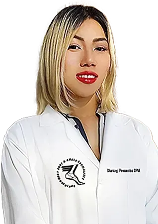 Female podiatrist in white coat smiling confidently.