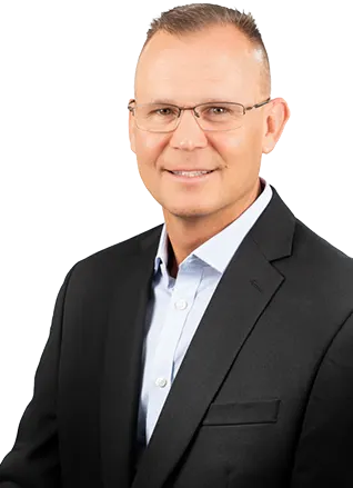 Professional individual in a suit with glasses against a white background.